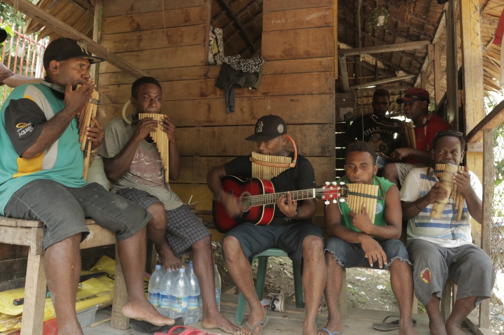 Musicians performing on bamboo panpipes and guitar, recorded by A Tree With Roots Music