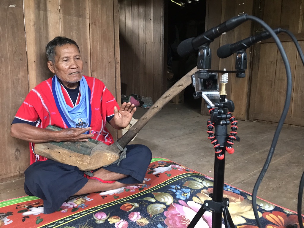 Bookoo Sandoh playing the tenaku while ATWR records him with microphones and a camera on a tripod